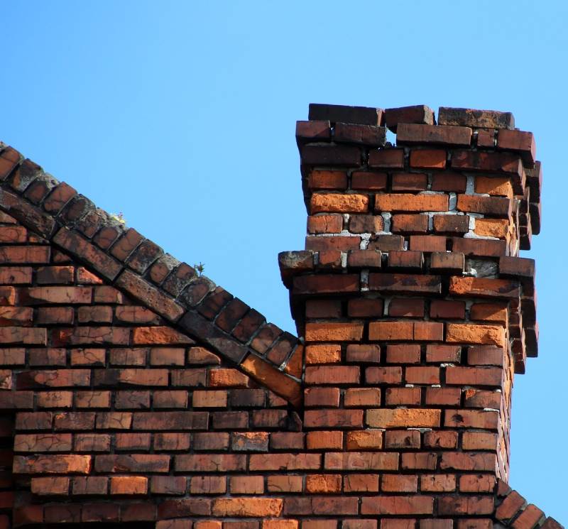 Signs Your Weymouth Home Needs a Chimney Inspection Damaged chimney on an Weymouth home showing cracks and missing mortar